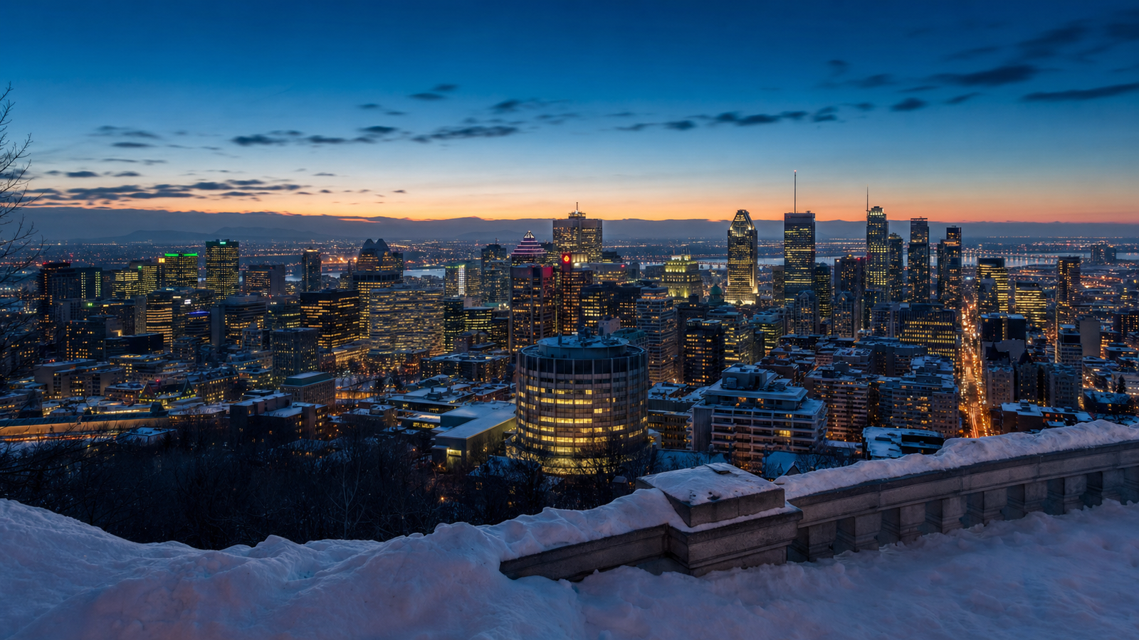 Snowy panoramic view of downtown Montréal from Mount Royal at dusk